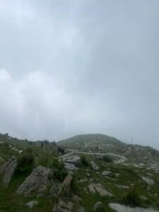 Scenic view of Himani Chamunda Trek with Himalayan peaks and lush green meadows