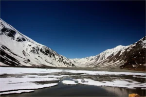 Snow-covered Baralacha La Pass with winding mountain road in Himachal